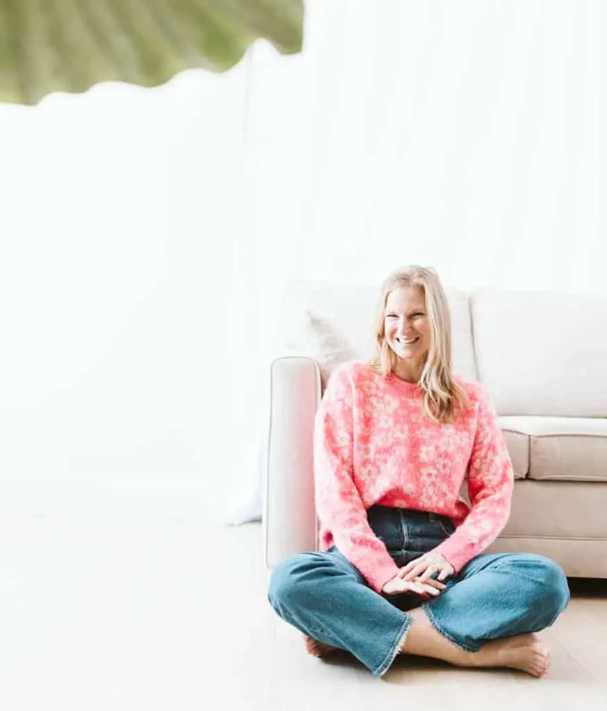 Dr. Joyce sitting on floor in front of sofa