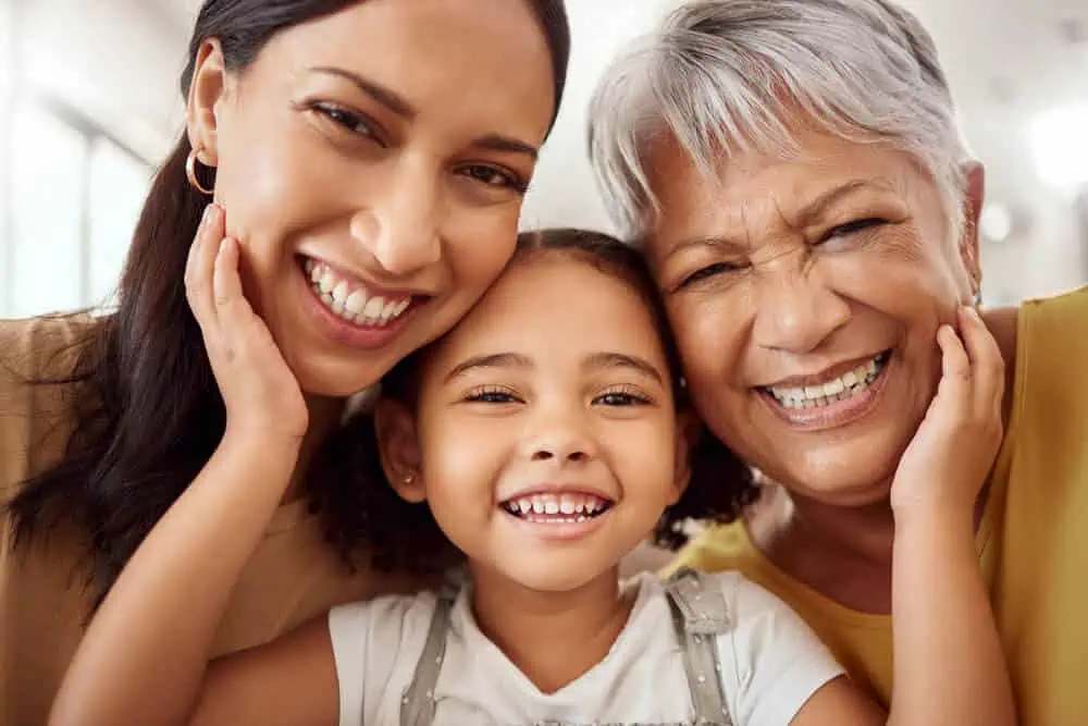 3 generations of women smiling for the camera
