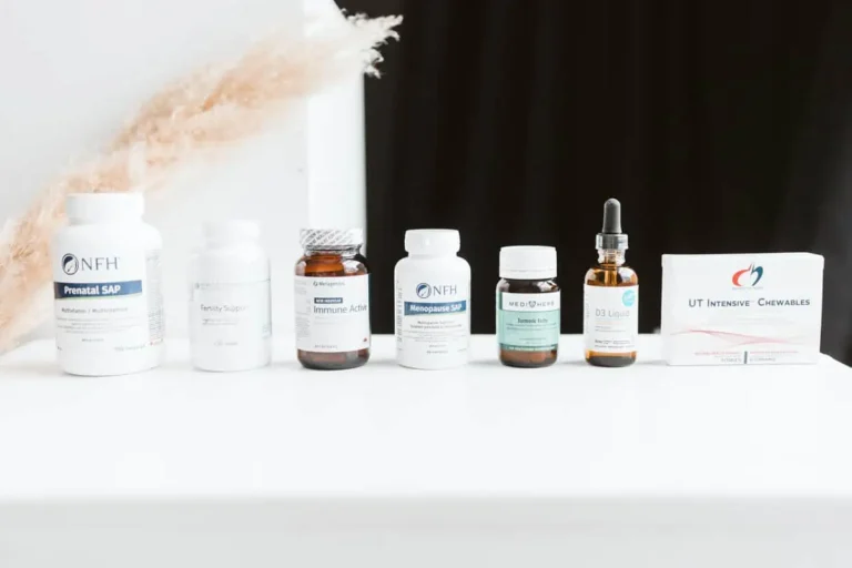 A variety of pills and supplement bottles lined up on a table