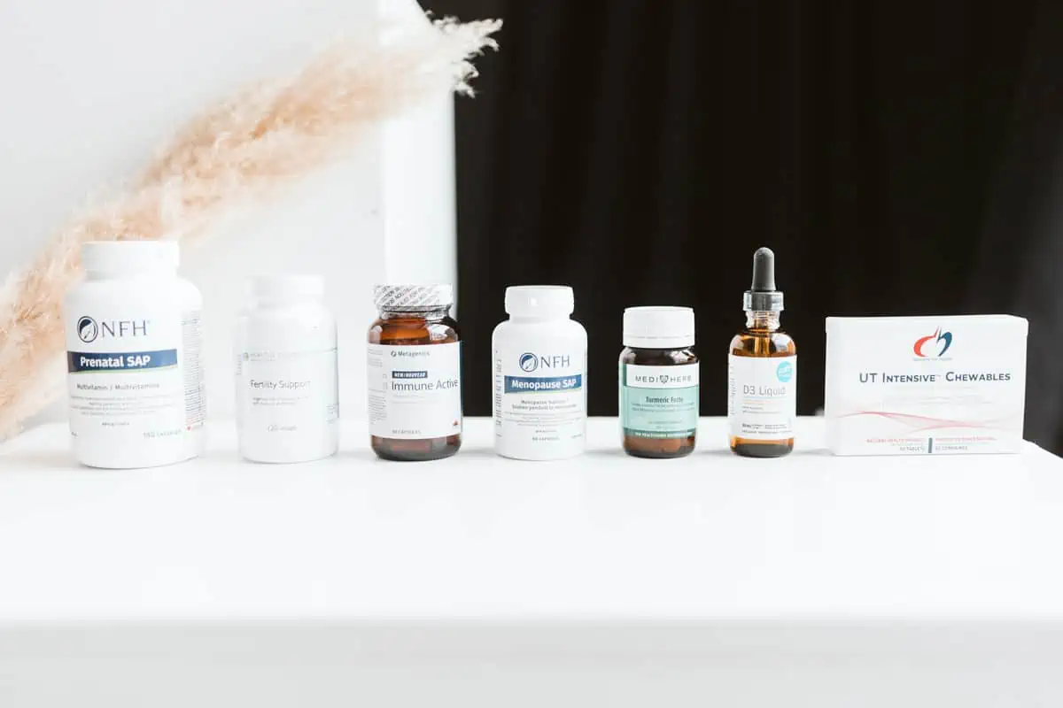 A variety of pills and supplement bottles lined up on a table