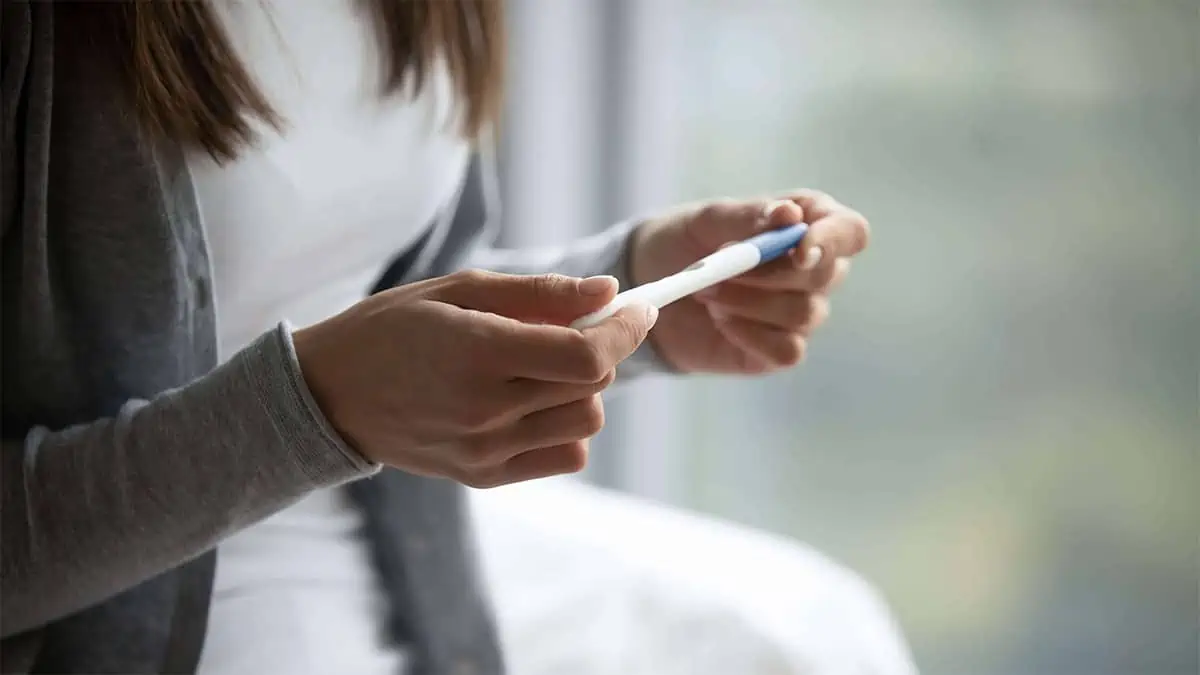 Close crop shot of a woman's hands holding a pregnancy test